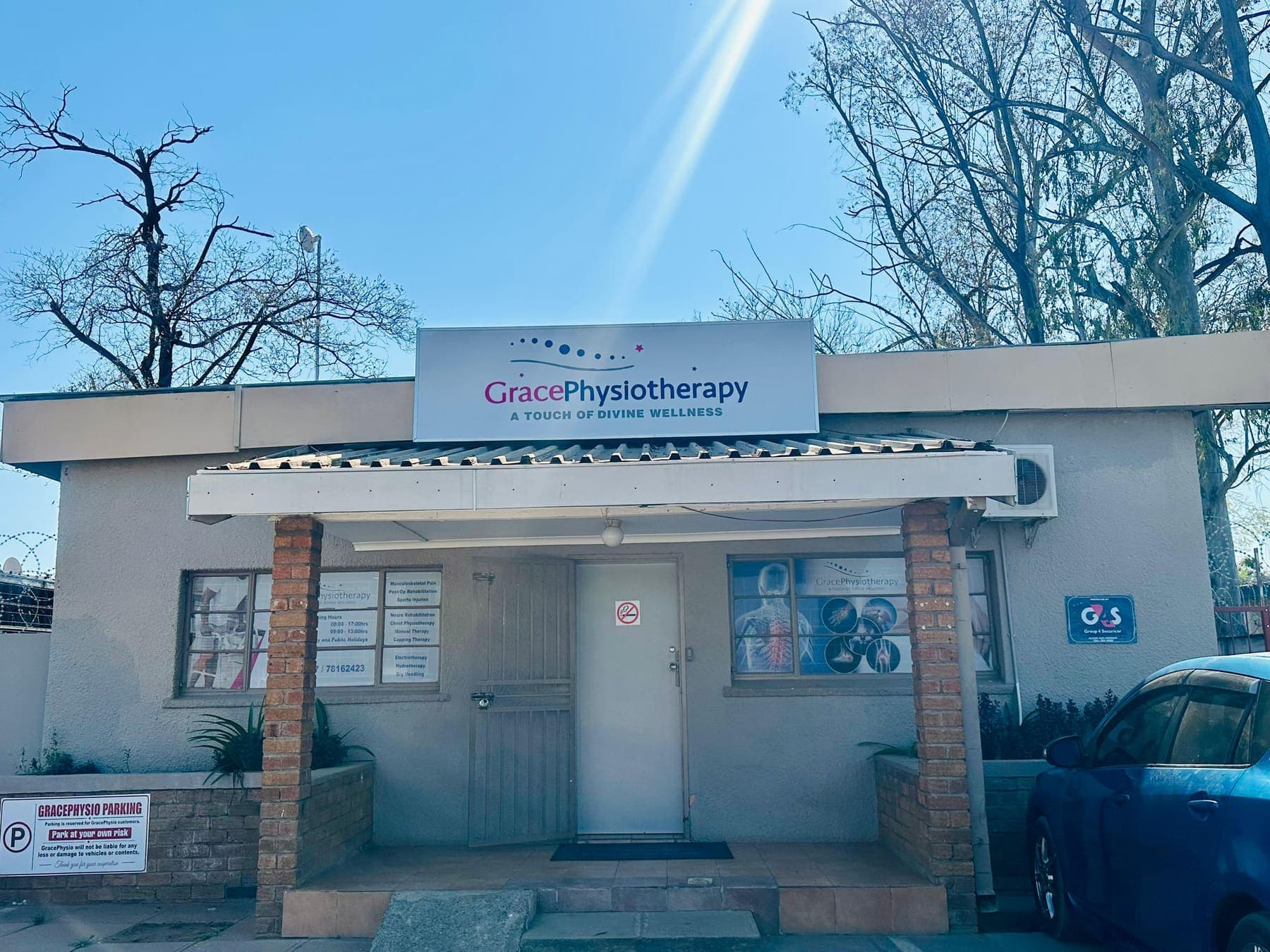 The Grace Physiotherapy clinic building on Kaunda Road with the practice's illuminated sign above the entrance canopy.