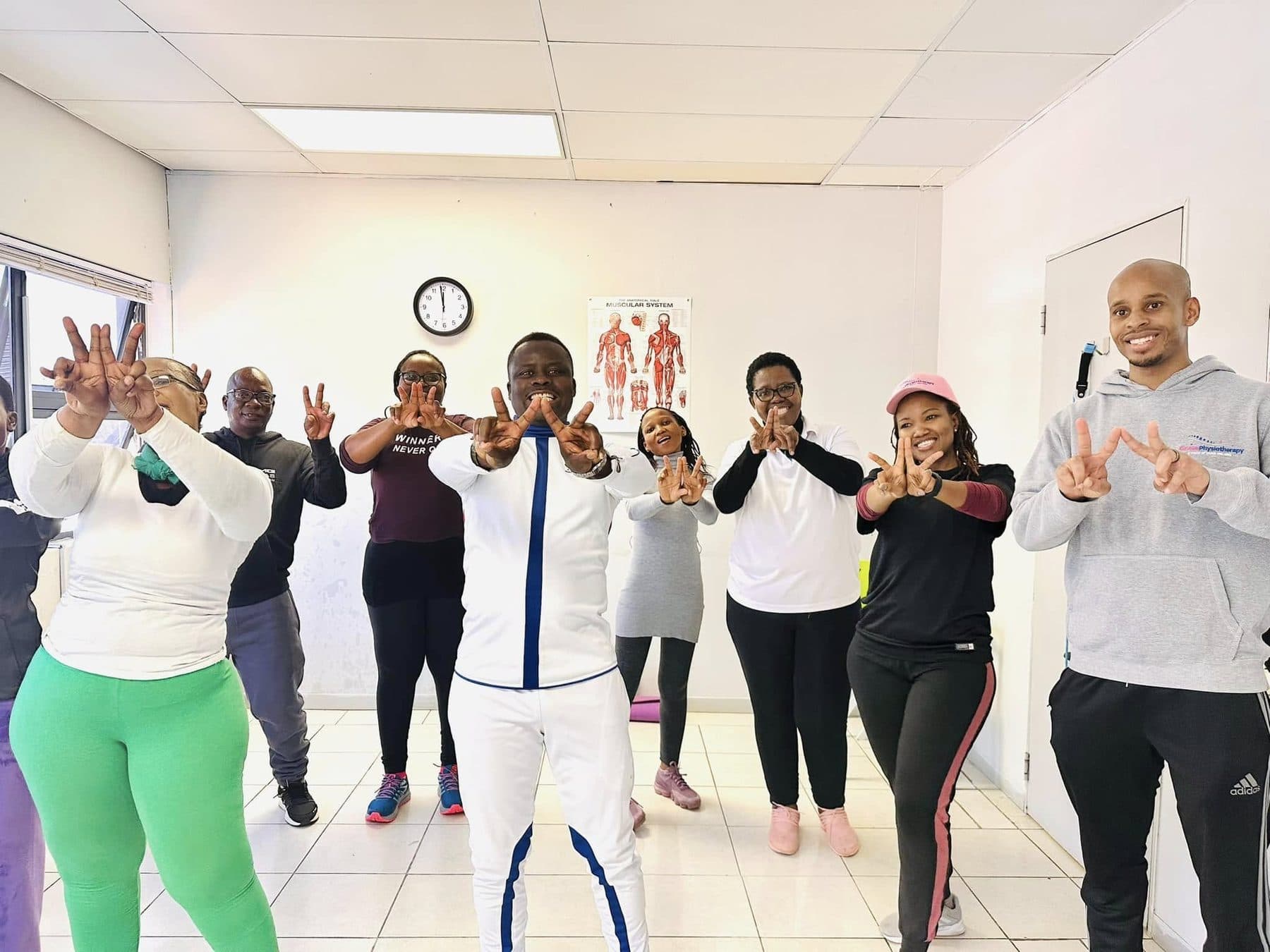 A Grace Physiotherapy group exercise class working through a standing mobility routine in the clinic.